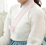 Closeup of woman sitting and wearing a custom womens bridal hanbok with white top and blue skirt