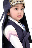 Young boy wearing a navy korean hanbok and looking up