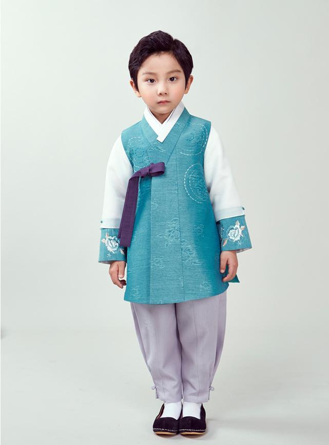Young boy wearing a sky blue hanbok and purple pants