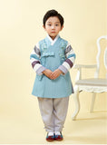 Young boy wearing a slate blue hanbok and clasping his hands