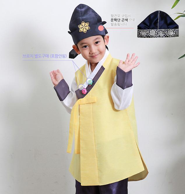 Young boy wearing a sunny yellow hanbok and blue hat