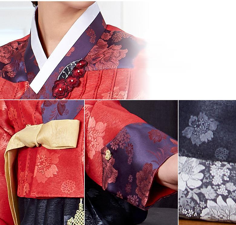 Woman wearing custom mother of the bride hanbok with red top and navy skirt closeup