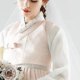 Closeup of Woman wearing a custom womens bridal hanbok in lace and pastel pink style