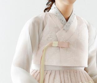 Closeup of top of custom womens bridal hanbok in lace and pastel pink style