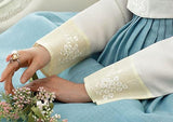 Closeup of hands of woman sitting and wearing a custom womens bridal hanbok with white top and blue skirt
