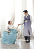 Woman talking to man and wearing a custom womens bridal hanbok with white top and blue skirt