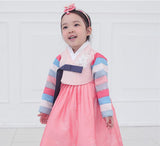Young girl wearing a girls korean hanbok with pink top and skirt
