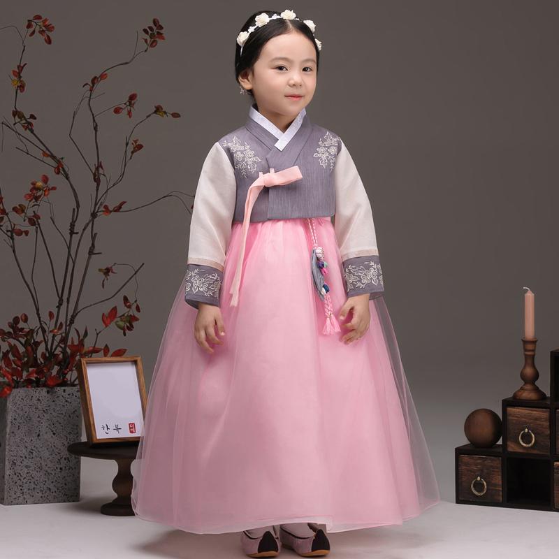 Young girl wearing a girls korean hanbok with lavender top and pink skirt