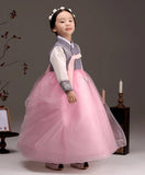 Young girl wearing a girls korean hanbok with lavender top and pink skirt