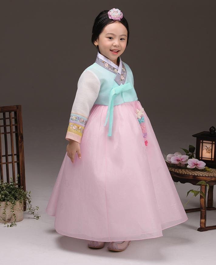 Young girl wearing a girls korean hanbok with pastel blue top and pink skirt