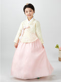 Young girl wearing a girls korean hanbok with pastel yellow top and pink skirt