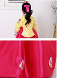 Closeup of skirt of a girls korean hanbok with yellow top and bright red skirt