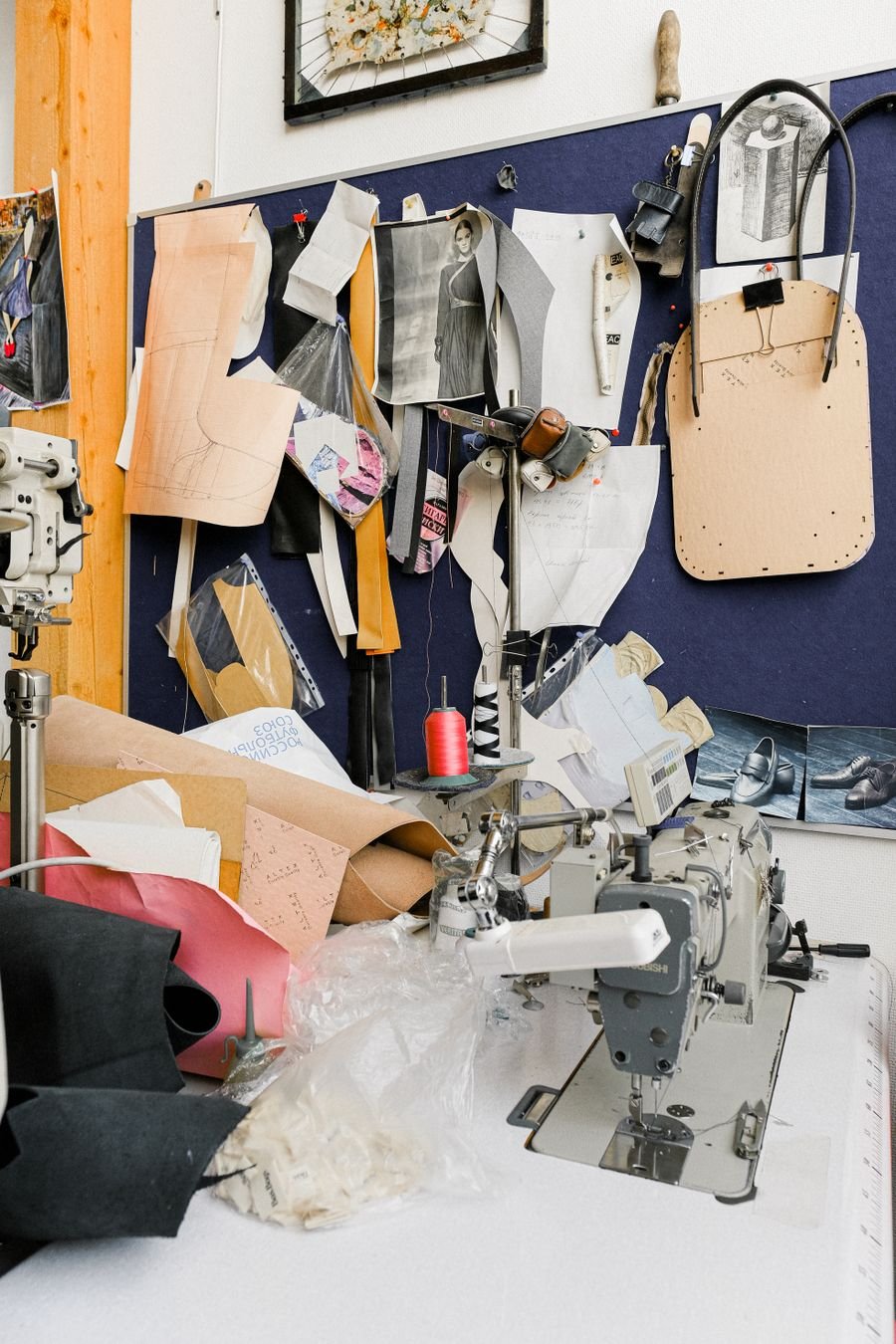 A sewing studio in detail — machine, patterns, and thread.