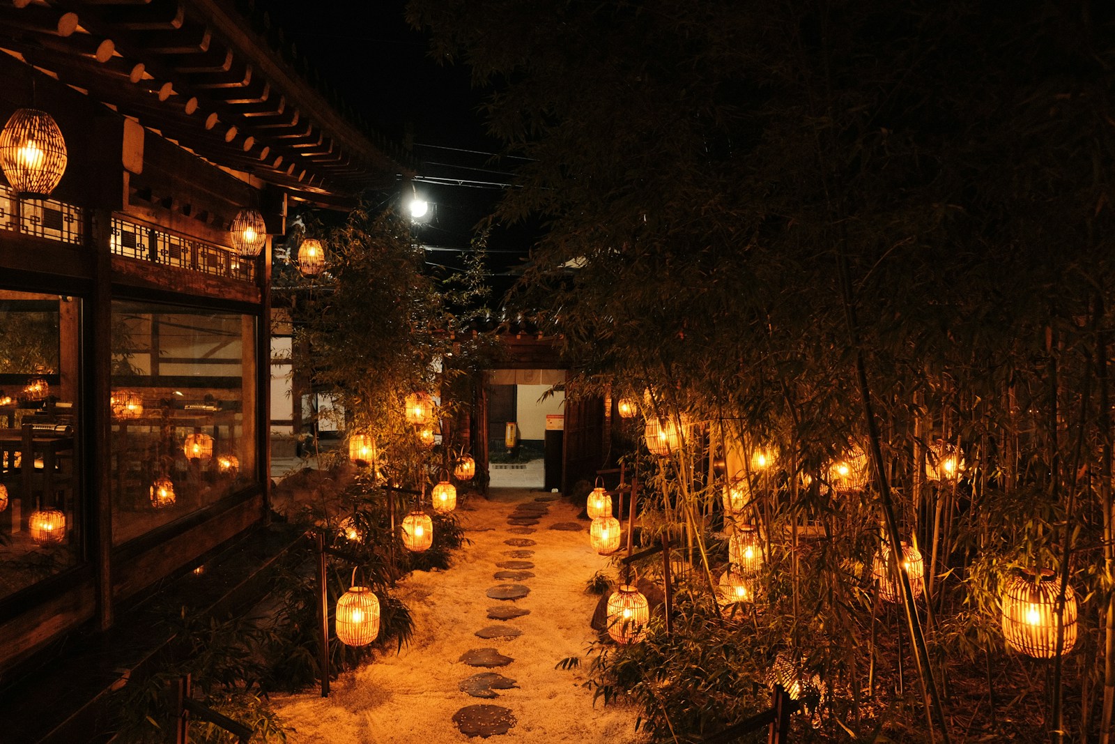 a path lined with lots of lit up lanterns