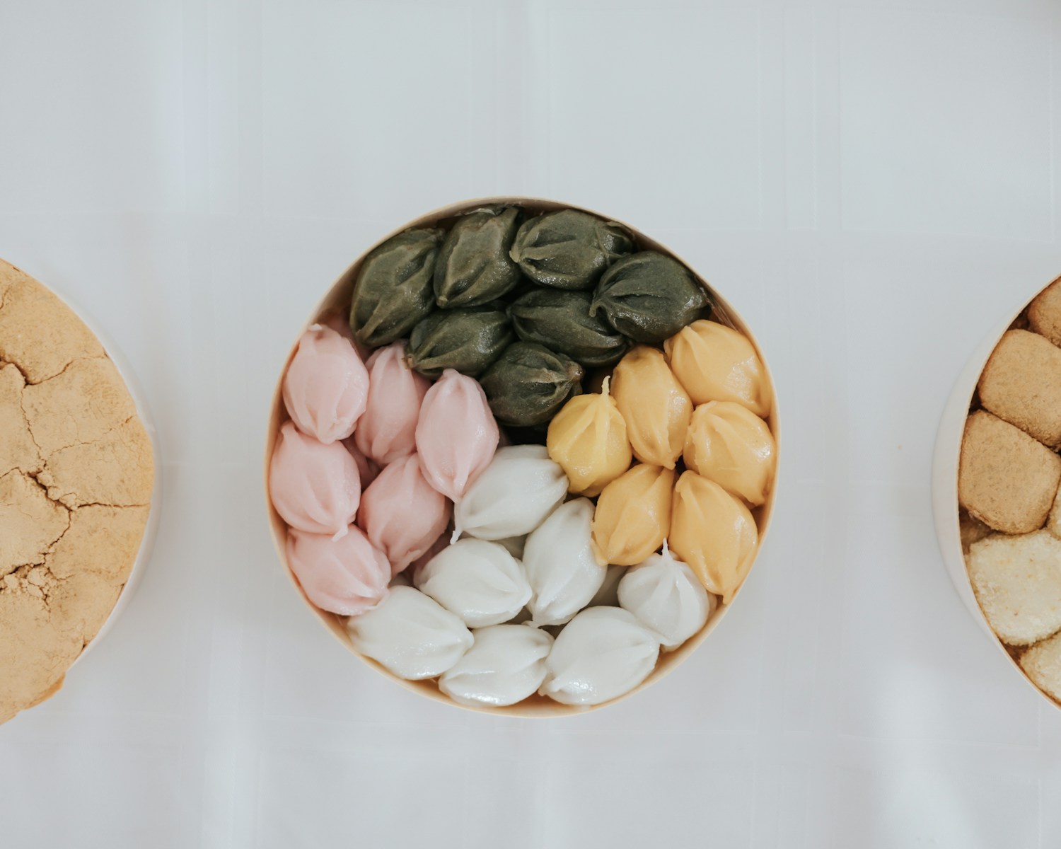 three bowls filled with different types of cookies