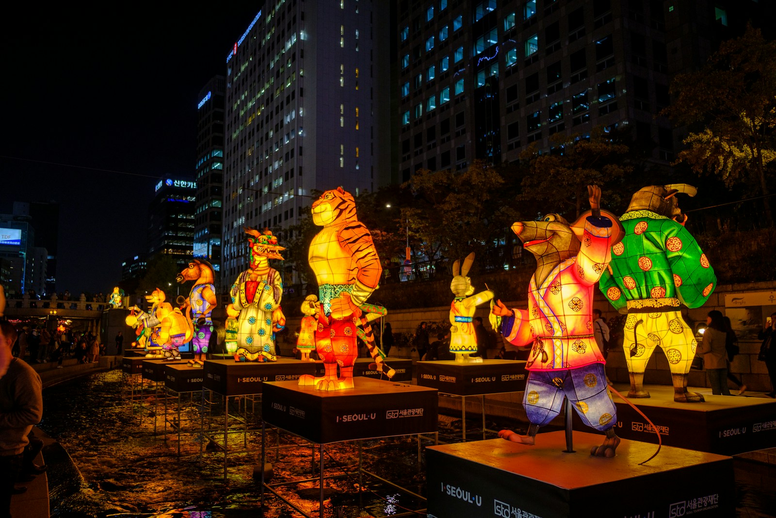 people standing on brown wooden table during night time